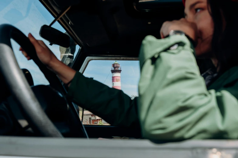 a woman talking on a cell phone while driving a truck, a picture, by Tobias Stimmer, pexels contest winner, lighthouse, in the style wes anderson, bottom viev, looking from shoulder