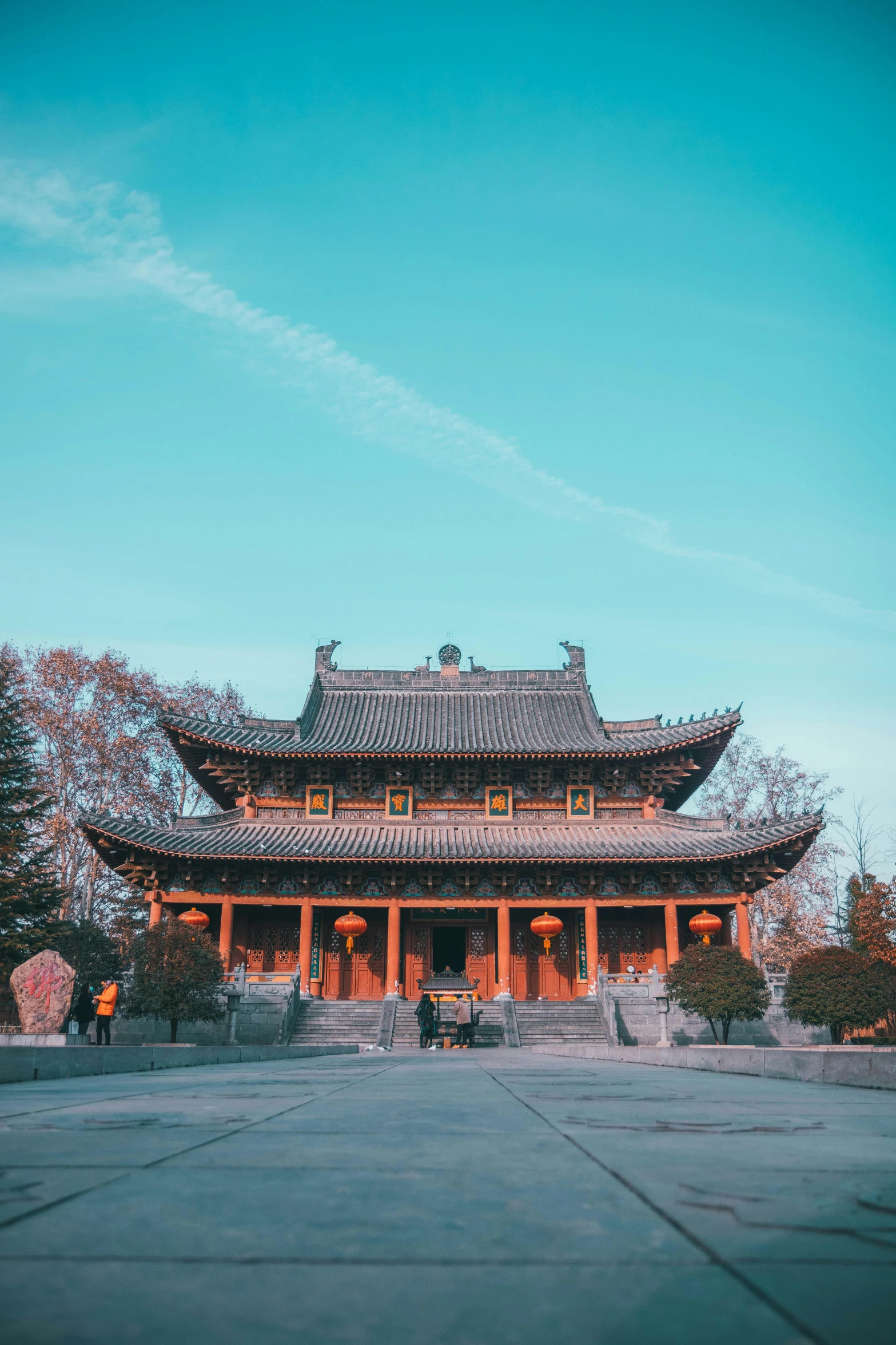 a large building sitting in the middle of a park, inspired by Wang Yi, pexels contest winner, chinese costume, square, brown and cyan color scheme, movie photo