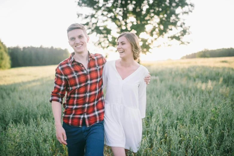 a man and woman walking through a field, pexels contest winner, both smiling for the camera, handsome girl, minna sundberg, wearing a linen shirt