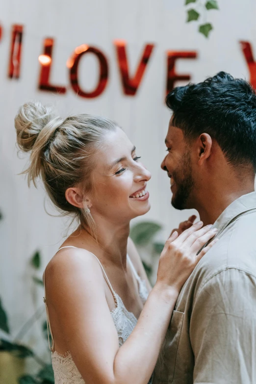 a man and a woman standing next to each other, pexels contest winner, romanticism, smiling seductively, topknot, dating app icon, bright daylight indoor photo