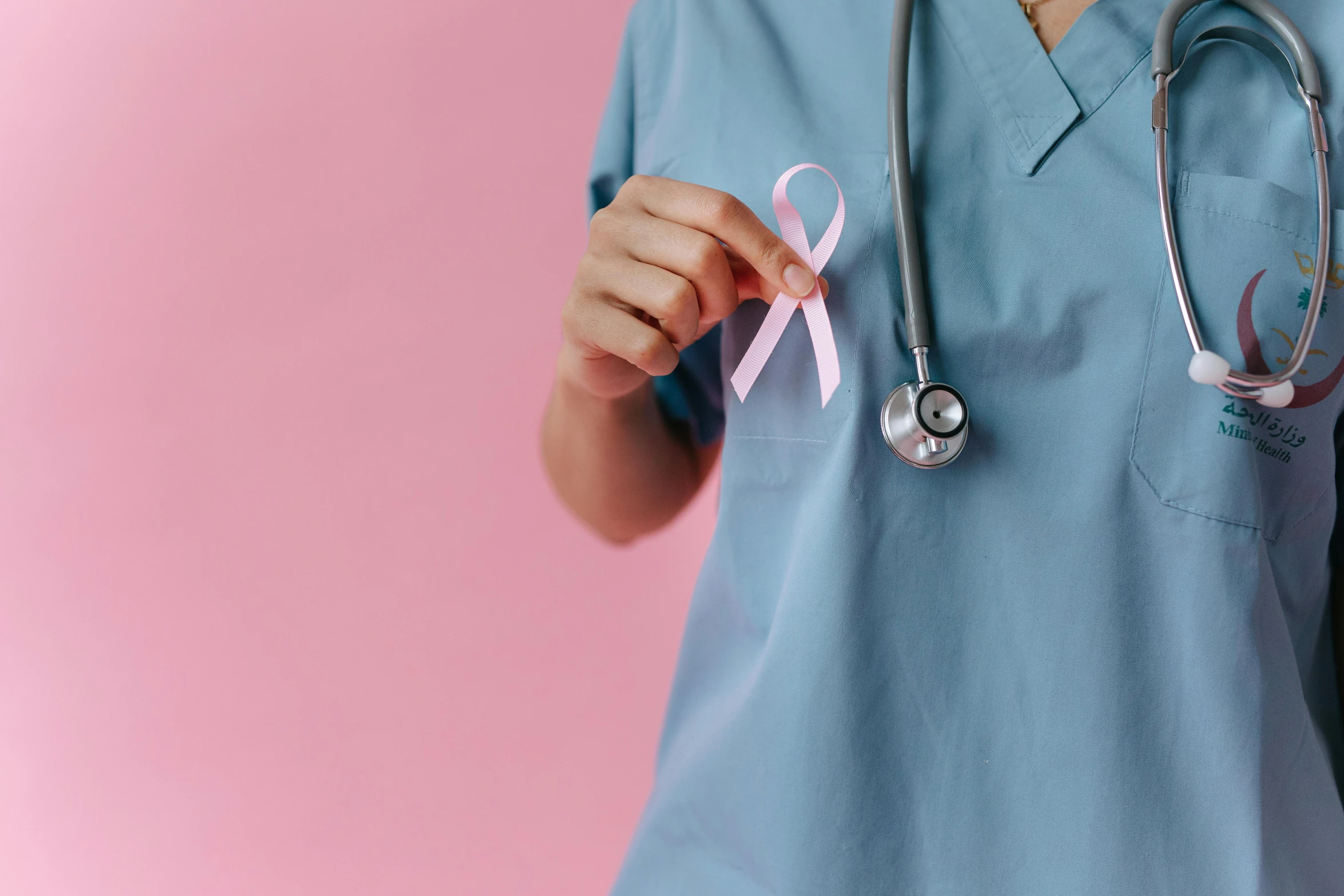 a woman with a stethoscope holding a pink ribbon, a photo, trending on pexels, hurufiyya, wearing a light blue shirt, nurse costume, thumbnail, background image