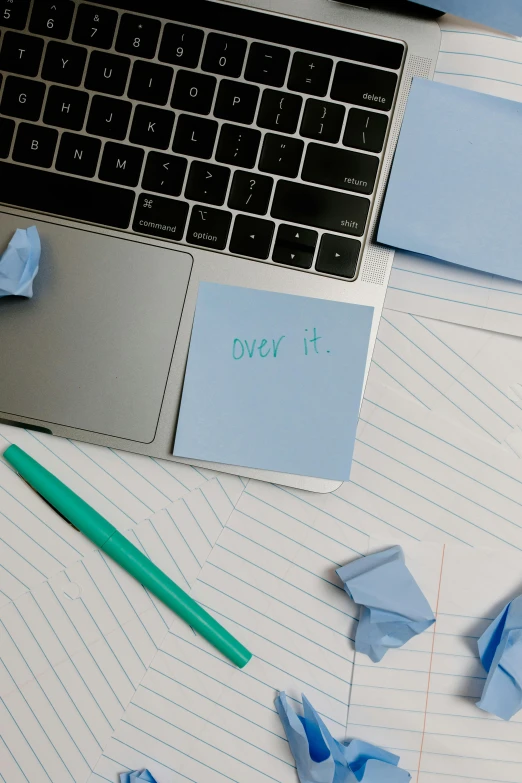 a laptop computer sitting on top of a desk, pexels, happening, teal paper, devastated, thumbnail, background image