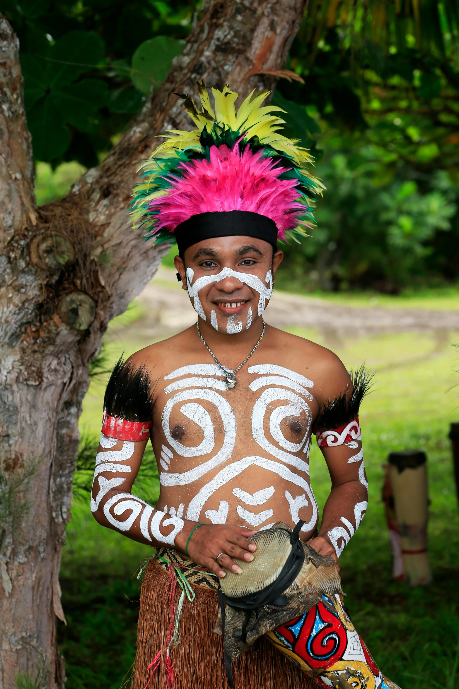 a man that is standing next to a tree, a tattoo, wearing authentic attire, face paint, album, colours