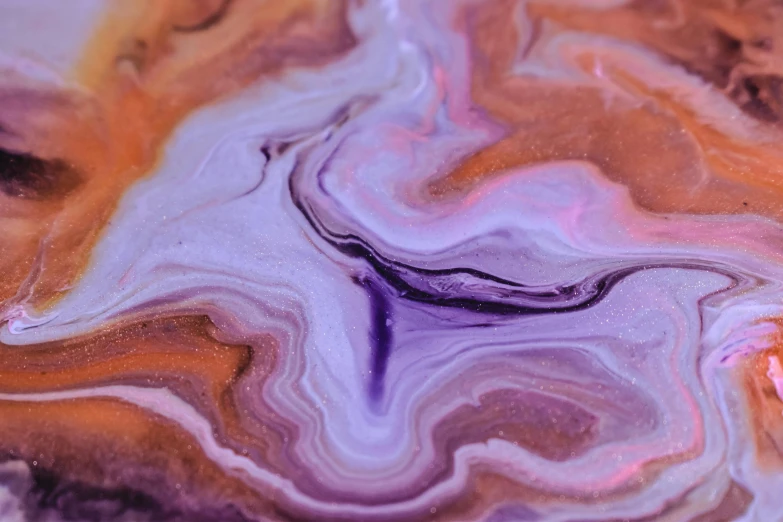 a piece of marble sitting on top of a table, inspired by Michelangelo, trending on pexels, process art, orange and purple color scheme, made of liquid purple metal, psychedelic waves, earth and pastel colors