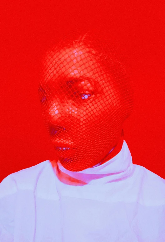 a woman standing in front of a red background, inspired by Carrie Mae Weems, afrofuturism, red mesh in the facede, aerochrome eyes, white skin and reflective eyes, an ai generated image