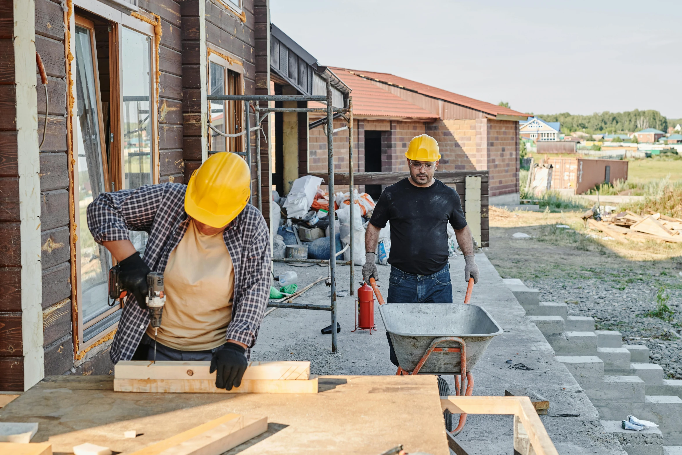 a couple of men standing next to a building, pexels contest winner, arbeitsrat für kunst, bright construction materials, working hard, people looking at a house, background image