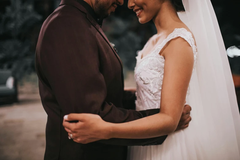 a man and a woman standing next to each other, pexels contest winner, romanticism, close up half body shot, groom, brown, te pae