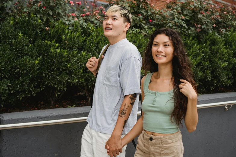 a man and a woman standing next to each other, trending on pexels, happening, of taiwanese girl with tattoos, casual summer clothes, nonbinary model, 15081959 21121991 01012000 4k