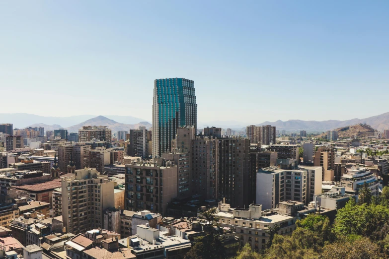 a view of a city from the top of a hill, by Alejandro Obregón, pexels contest winner, full daylight, high rise buildings, chile, 4 k cinematic panoramic view