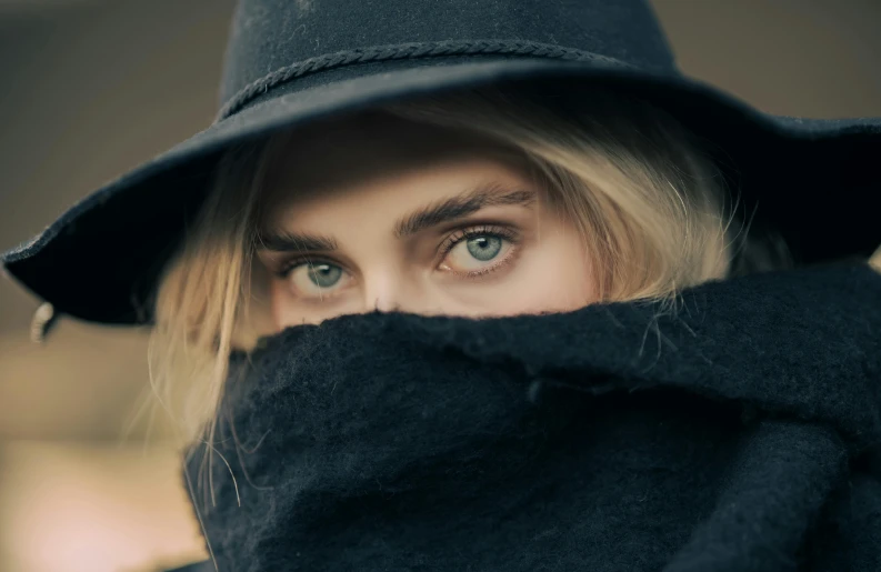 a woman wearing a black hat and scarf, trending on pexels, surrealism, blue - eyes, hiding, cara delevigne, extremely handsome