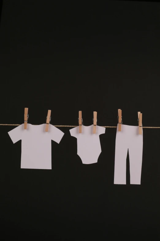clothes hanging on a clothes line on a black background, a cartoon, pexels contest winner, minimalism, diaper-shaped, on white paper, 15081959 21121991 01012000 4k, no - text no - logo