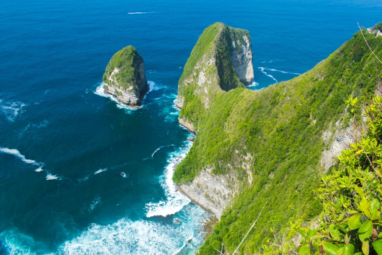 two large rocks in the middle of a body of water, by Daniel Lieske, pexels contest winner, sumatraism, steep cliffs, avatar image, island in a blue sea, lush vista