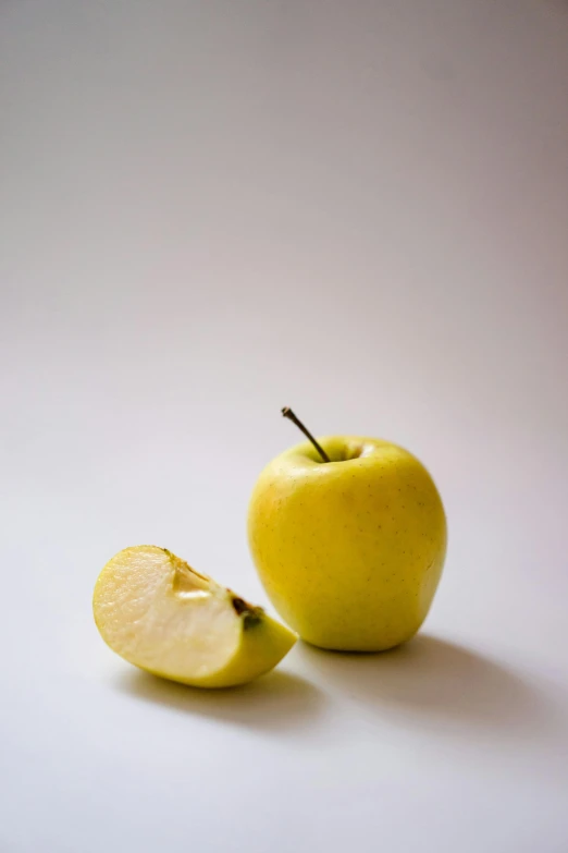 an apple with a bite taken out of it, a picture, by Leonard Appelbee, pexels, yellow apples, minimalist photorealist, a blond, cut-scene