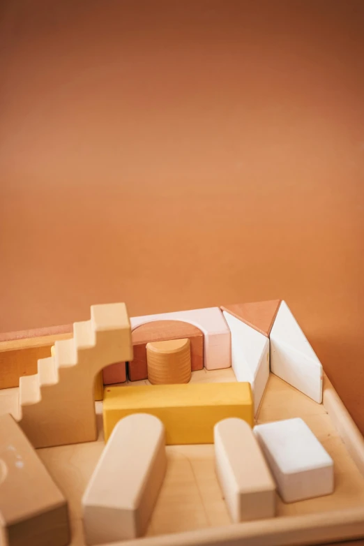 a piece of cheese sitting on top of a tray, an abstract sculpture, inspired by Isamu Noguchi, trending on unsplash, toys, bricks, sand color, axonometric