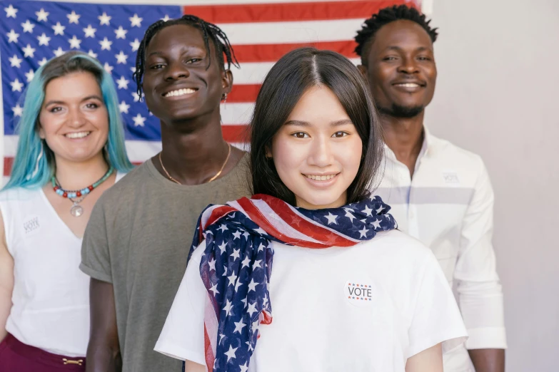 a group of people standing in front of an american flag, young asian woman, background image, adut akech, presidental elections candidates