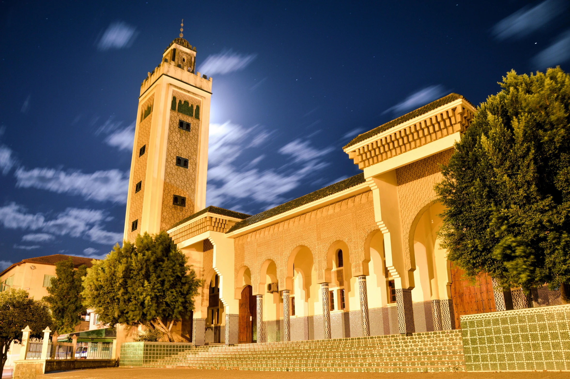 a large building with a clock tower in the background, a picture, hurufiyya, moroccan mosque, beatifully lit, university, thumbnail