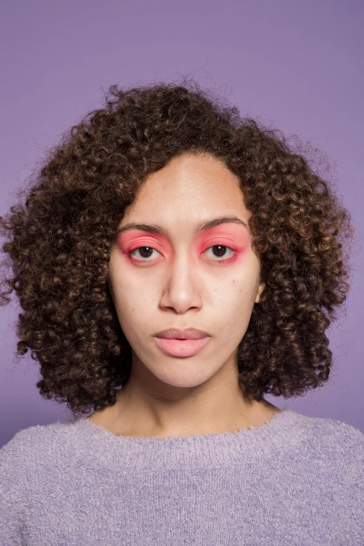 a woman with a pink eye shadow on her face, by Lily Delissa Joseph, color field, curls on top, red left eye, press shot, face symmetrical
