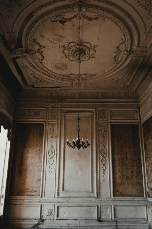 an empty room with a chandelier hanging from the ceiling, unsplash contest winner, rococo, muted browns, architectural finishes, tall, old house