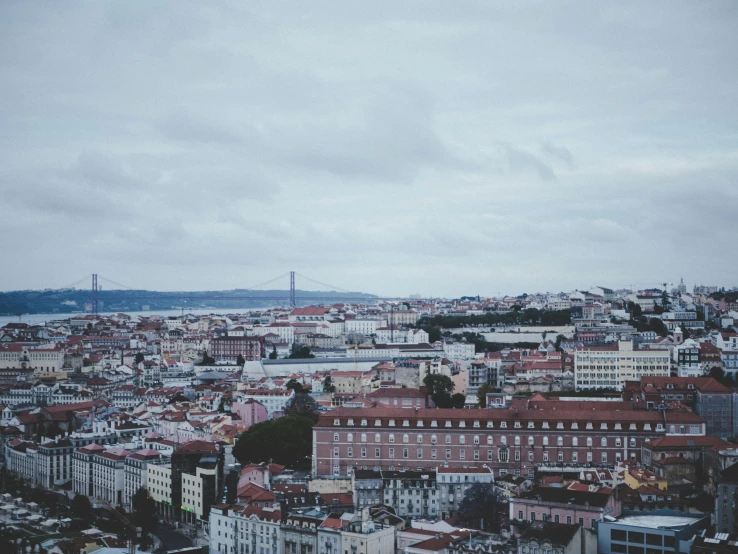 a view of a city from the top of a building, pexels contest winner, the raining city of lisbon, overcast gray skies, pastel', square