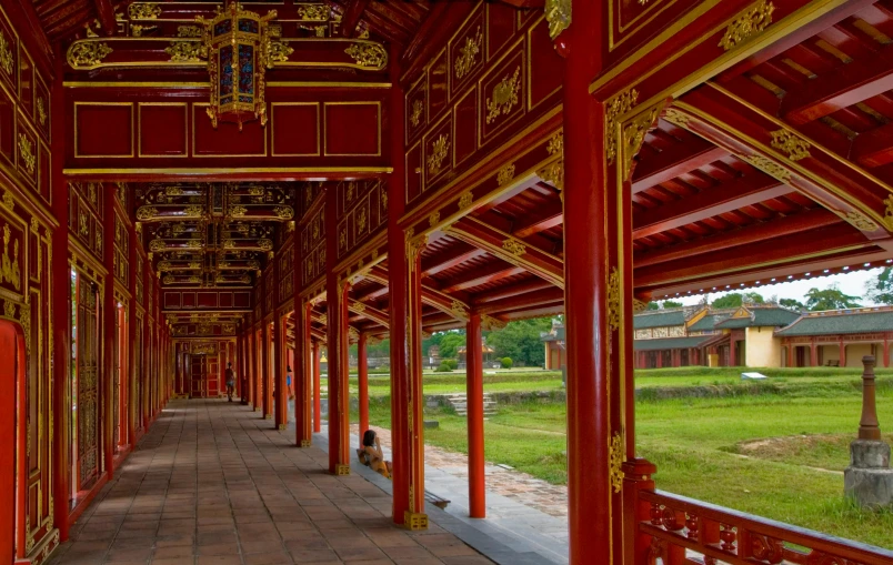 a walkway lined with red and gold columns, inspired by Steve McCurry, pexels contest winner, cloisonnism, vietnamese temple scene, square, the imperial palace, high-quality photo