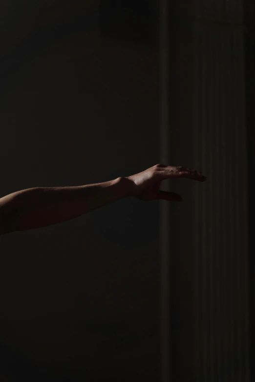 a man holding a tennis racquet on top of a tennis court, by Alexis Grimou, light and space, hands reaching for her, in a black room, close-up of thin soft hand, promo image