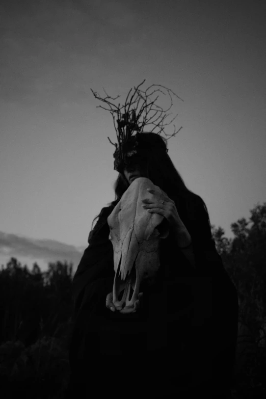 a black and white photo of a person with a horse's skull, an album cover, by Yerkaland, unsplash, pagan, late evening, overgrowth, headless