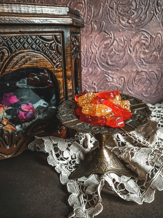 a close up of a plate of food on a table, a still life, by Emma Andijewska, unsplash, art nouveau, gummy candies, ornate with fiery explosions, gothic antique theme, detailed product image