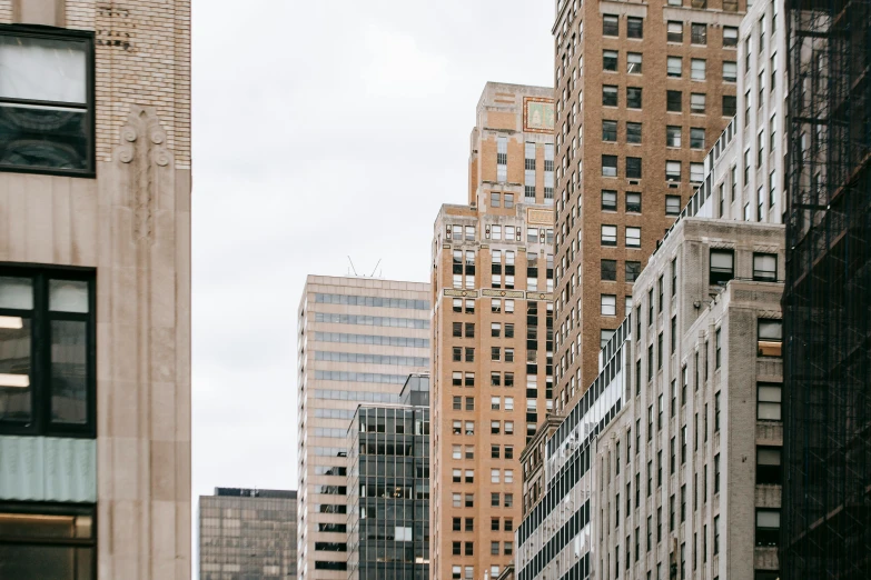 a city street filled with lots of tall buildings, by Carey Morris, pexels contest winner, modernism, background image, white pale concrete city, new york buildings, exterior photo