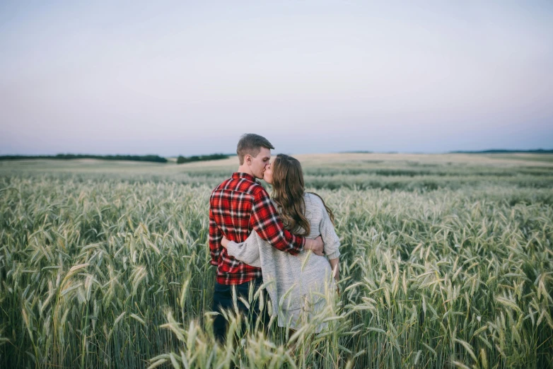 a couple standing in a field of tall grass, pexels contest winner, a cozy, striped, owen klatte, well built