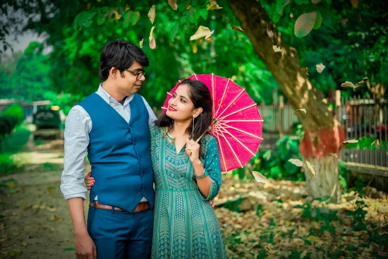 a man standing next to a woman holding an umbrella, a portrait, by Shekhar Gurera, instagram, romanticism, 15081959 21121991 01012000 4k, vibrant greenery, avatar image, dlsr photography