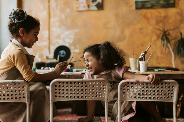 two little girls sitting at a table eating food, pexels contest winner, art & language, sitting on a mocha-colored table, future activist, sitting in the classroom, tables and chairs