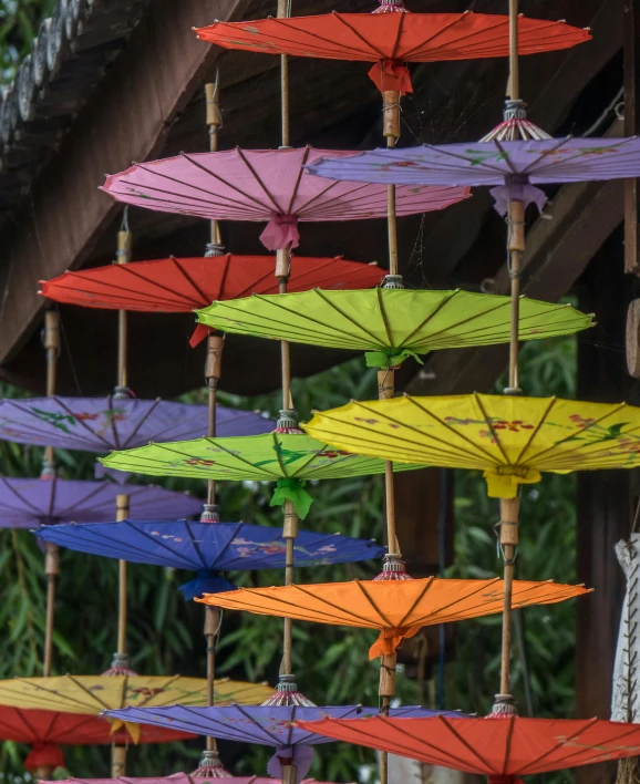 a bunch of umbrellas hanging from the side of a building, pagoda, coloured, square, paul barson
