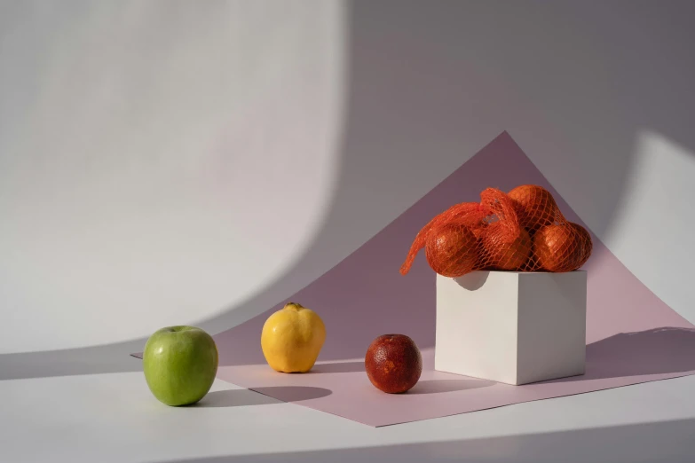 a white box filled with oranges and apples, a still life, inspired by Anna Füssli, shutterstock contest winner, ignant, soft volumetric lighting, angular minimalism, various colors