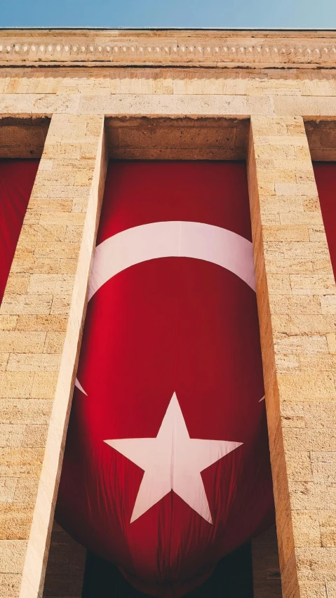 a large flag hanging from the side of a building, pexels contest winner, hurufiyya, turkish and russian, square, 15081959 21121991 01012000 4k, birdseye view