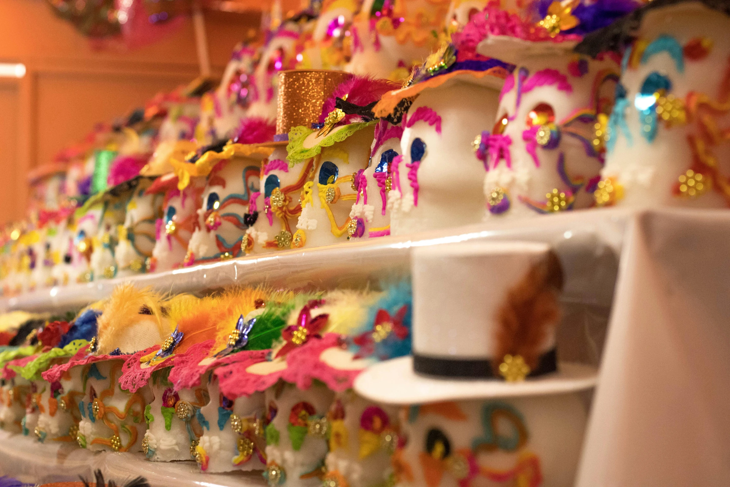 a bunch of cupcakes that are on a shelf, vanitas, folklorico, profile image, hats, made of colorful dried flowers