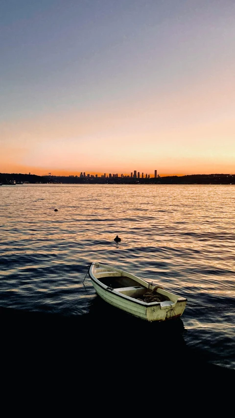 a small boat sitting on top of a body of water, by John Murdoch, pexels contest winner, hurufiyya, seattle, warm summer nights, fallout style istanbul, conde nast traveler photo