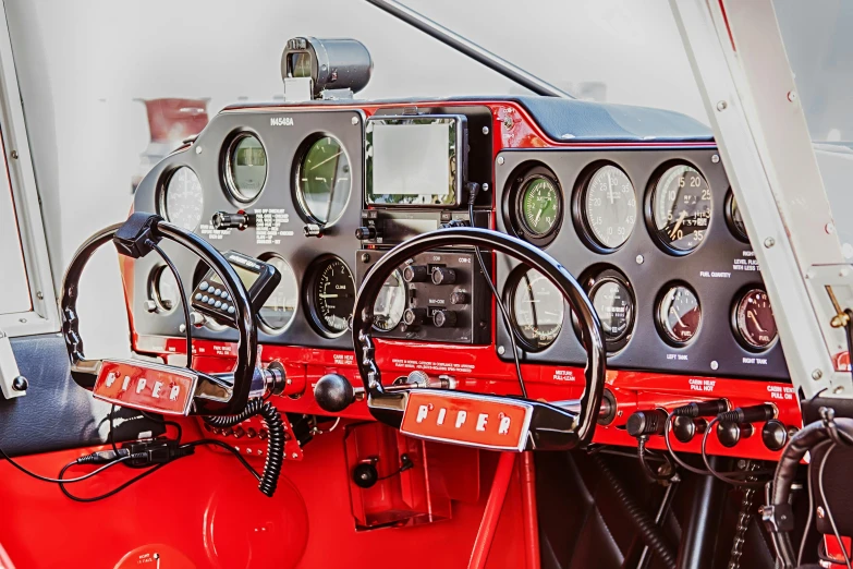 a close up of a cockpit of a plane, red, radios, vehicle photography, panoramic shot