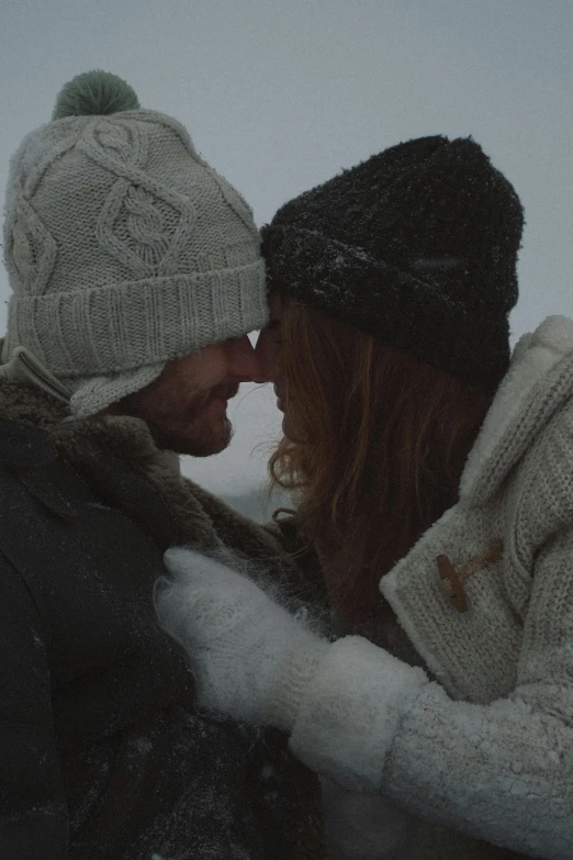 a man and a woman standing next to each other in the snow, pexels contest winner, romanticism, wearing wool hat, movie footage, promotional image, tenderness