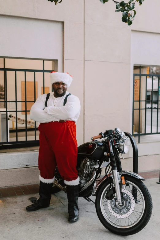 a man in a santa suit standing next to a motorcycle, pexels contest winner, black man, corporate memphis, casually dressed, hi-res
