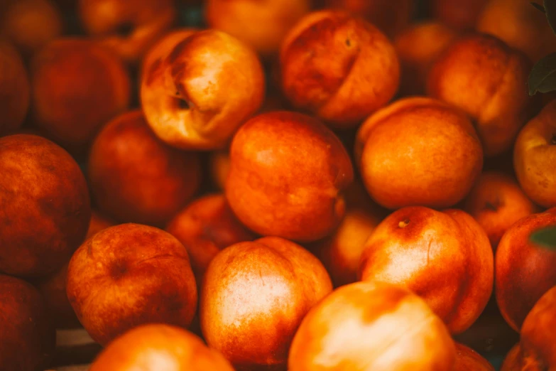 a pile of peaches sitting on top of each other, pexels, process art, background image, brown, instagram photo, warm shiny colors