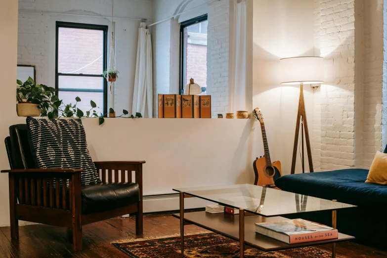 a living room filled with furniture and a guitar, pexels contest winner, light and space, city apartment cozy calm, a cozy old victorian loft, minimalist desk, meredith schomburg