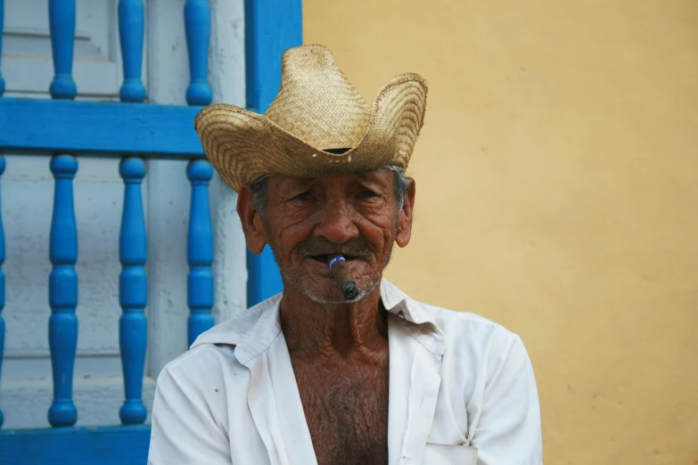 a man with a straw hat smoking a cigarette, inspired by Agustín Fernández, pexels contest winner, old village, avatar image, an ox, puerto rico