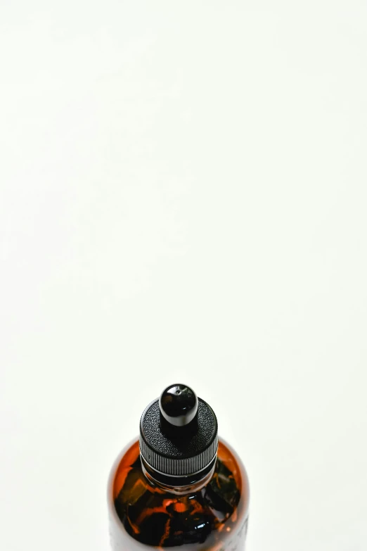 a bottle sitting on top of a white surface, by Doug Ohlson, hair fluid, low detail, image, maple syrup