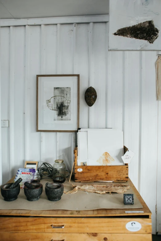 a desk with a bunch of items on top of it, a still life, visual art, inside a shed, white gallery, wabi - sabi, product display