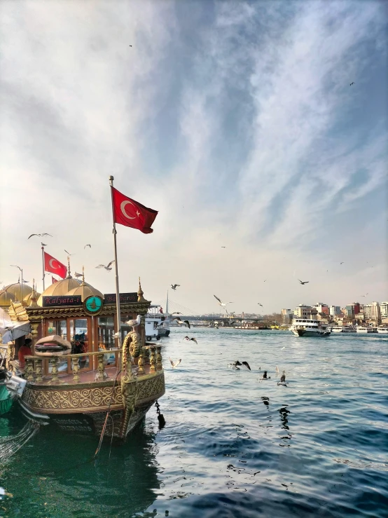 a group of boats floating on top of a body of water, a picture, inspired by Niyazi Selimoglu, pexels contest winner, hurufiyya, harbour in background, ottoman empire, youtube thumbnail, conde nast traveler photo