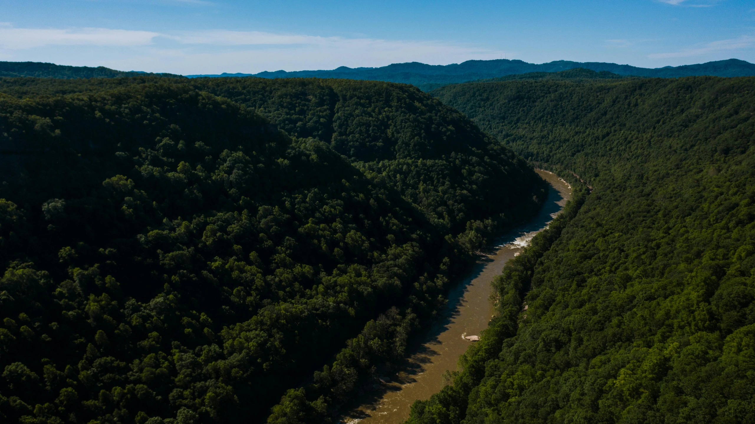 a river running through a lush green forest, by Doug Wildey, pexels contest winner, hudson river school, helicopter view, looking over west virginia, 4 k cinematic panoramic view, thumbnail
