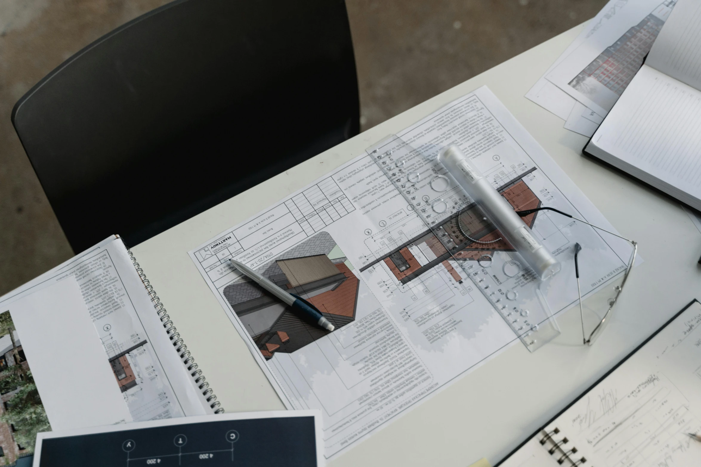 a laptop computer sitting on top of a table, a computer rendering, inspired by Richard Wilson, unsplash, photorealism, architectural plan, character sheets on table, mixed materials, in style of norman foster