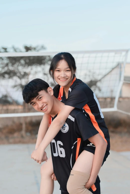 a man riding on the back of a woman on a skateboard, by Tan Ting-pho, pexels contest winner, happening, wearing a volleyball jersey, teen boy, both smiling for the camera, dang my linh