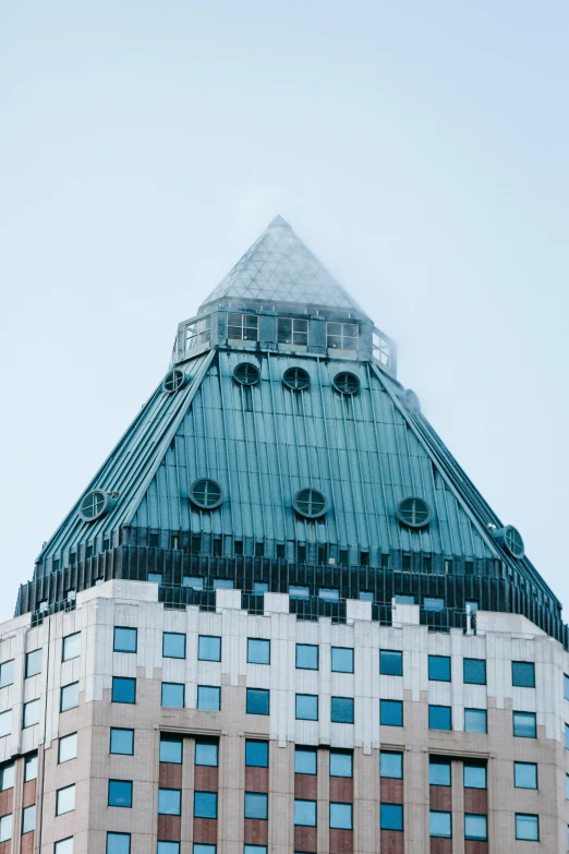 a tall building with a clock on top of it, trending on unsplash, vancouver school, pyramid visor, rounded roof, taken in 1 9 9 7, chateau frontenac