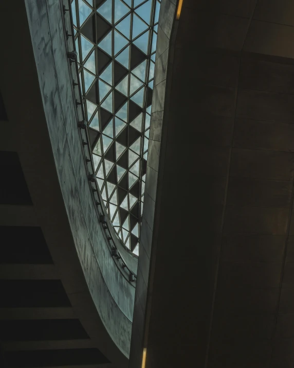 the sun shines through the glass roof of a building, an abstract sculpture, unsplash contest winner, window light, national portrait gallery, gray concrete, geodesic